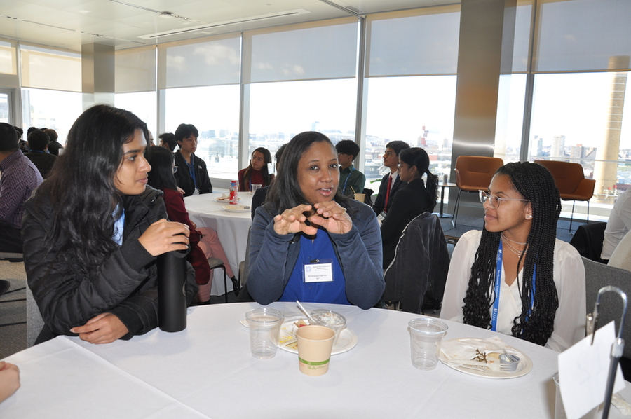 Kristala Prather talks with two students at the 2025 AJAS Breakfast with Scientists