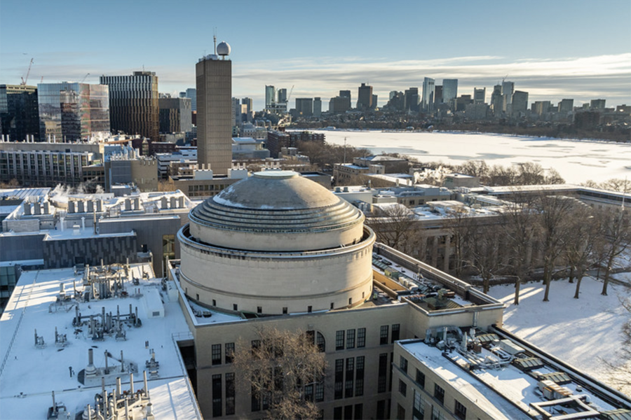 Aerial view of MIT campus covered in snow, looking east toward the Charles River and downtown Boston