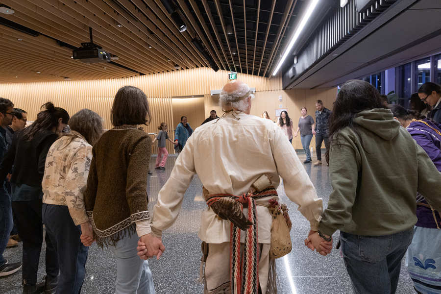 People hold hands in a circle