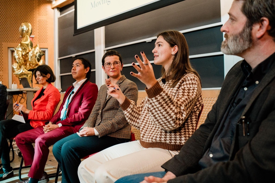 Five people seated in front of an auditorium
