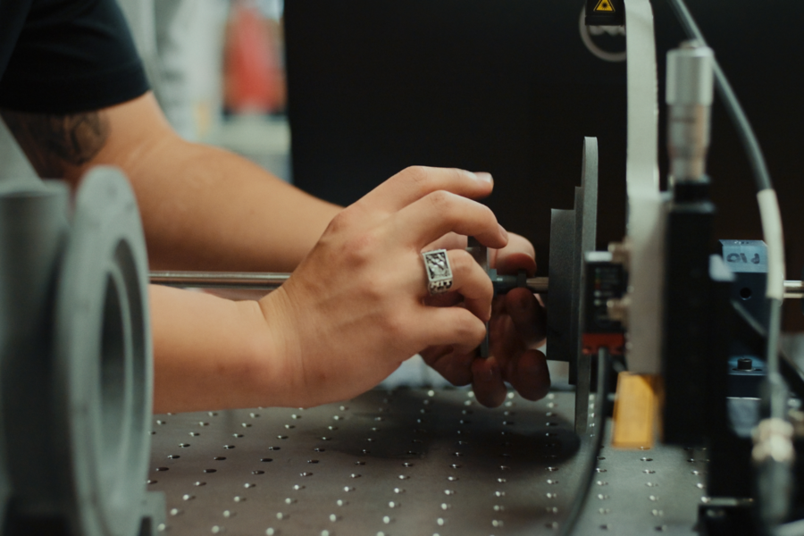Pair of hands adjusting a piece of machinery