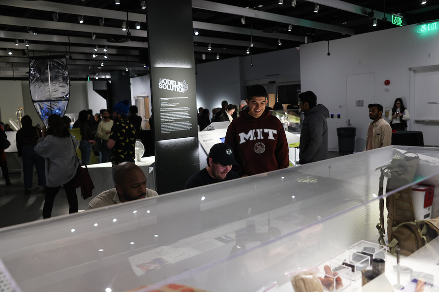 Several people look into a museum display case