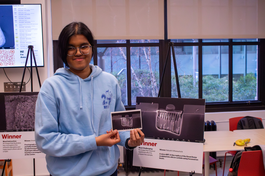 Nelushi Vithanachchi holds a postcard of the image that earned her an award