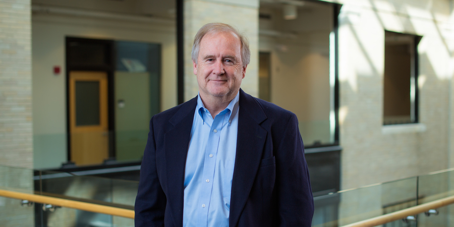 Craig Carter poses for a photo on the MIT campus