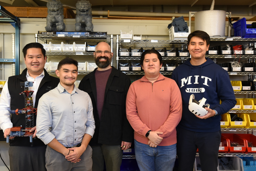Five people stand in the FrED factory at MIT