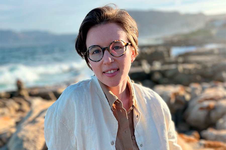 A portrait of Jess Speedie with the ocean in the background