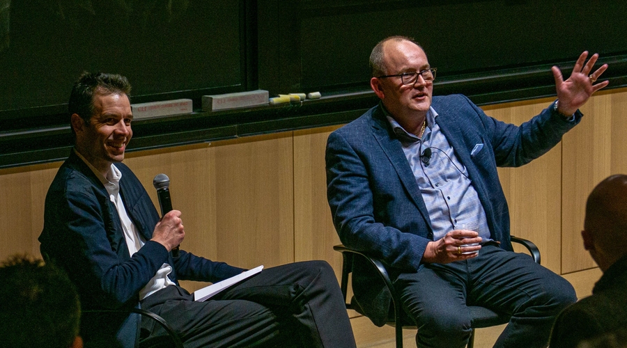 John Hart and Carsten Rasmussen sit at the front of an MIT lecture hall.
