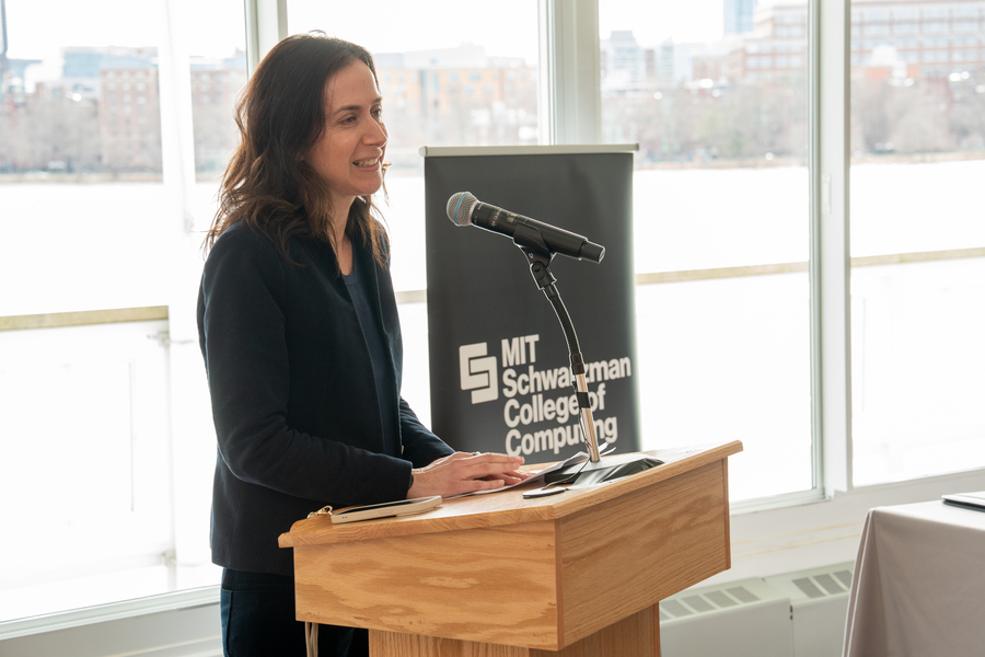 Fotini Christia addresses a room, standing at a lectern
