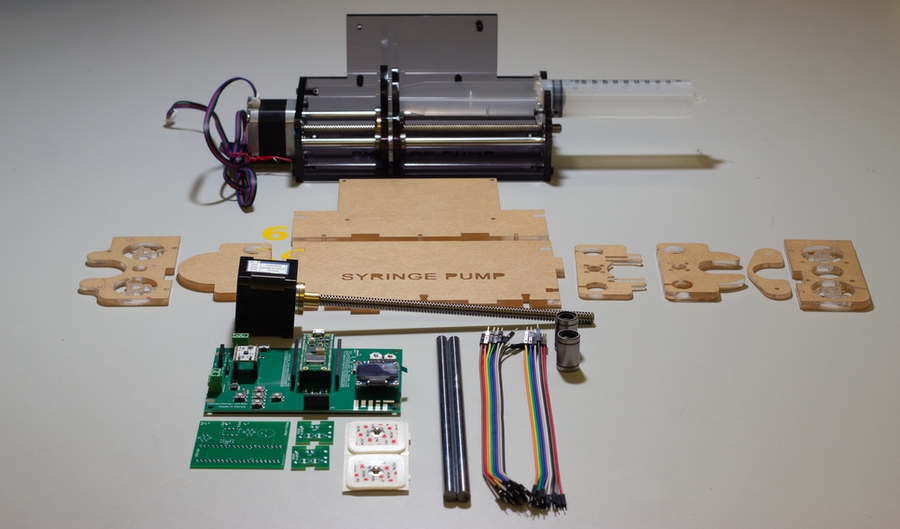 A biomedical device kit, neatly laid out to show included parts