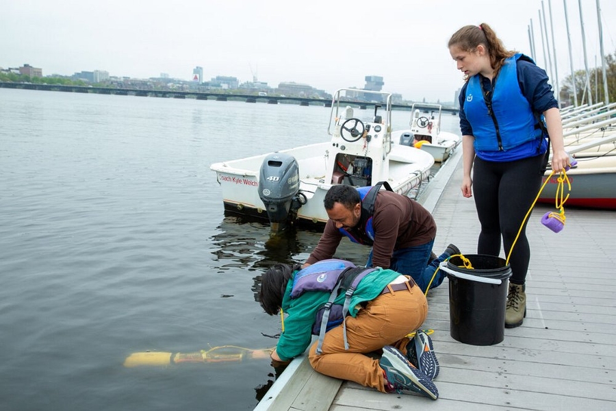 MIT students launch an autonomous underwater vehicle in the Charles River