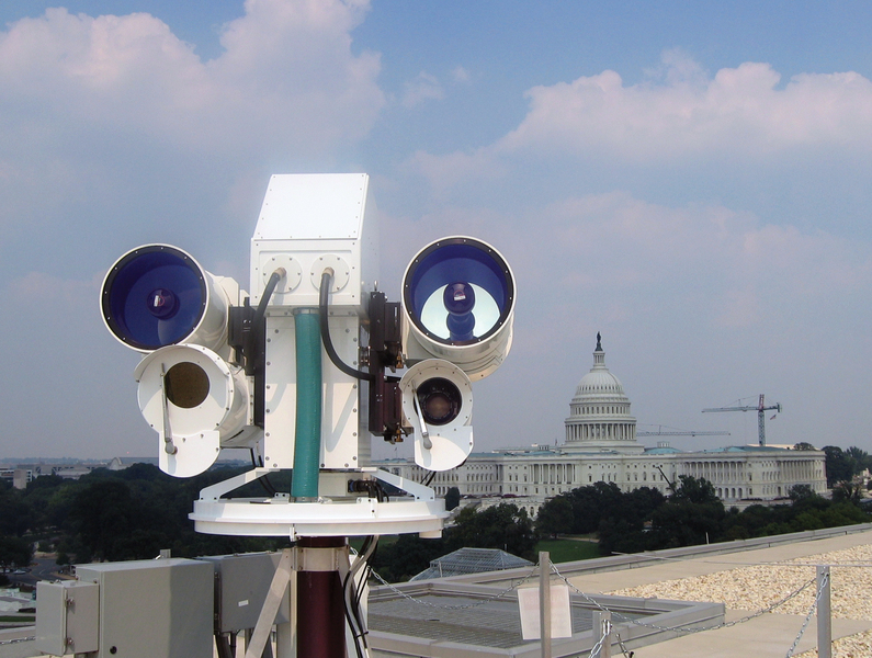 Imaging system hardware is installed on a rooftop in Washington; the Capitol building is visible in the background.