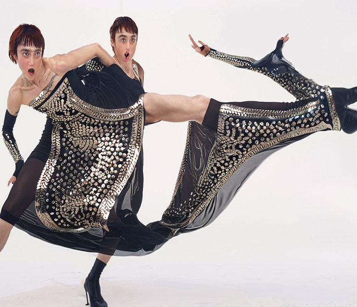AI image of two distorted human figures sharing the same metal-studded clothing