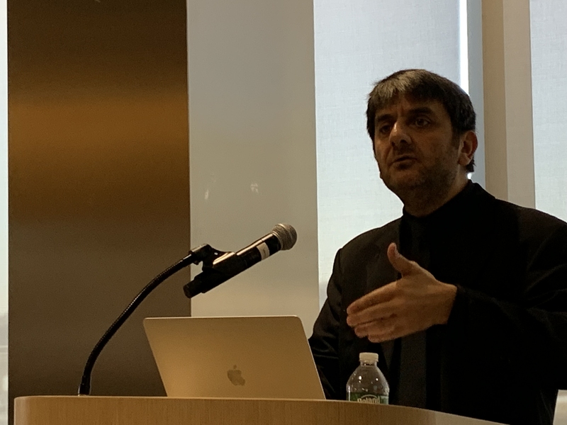 C. Cem Tasan standing at a lectern