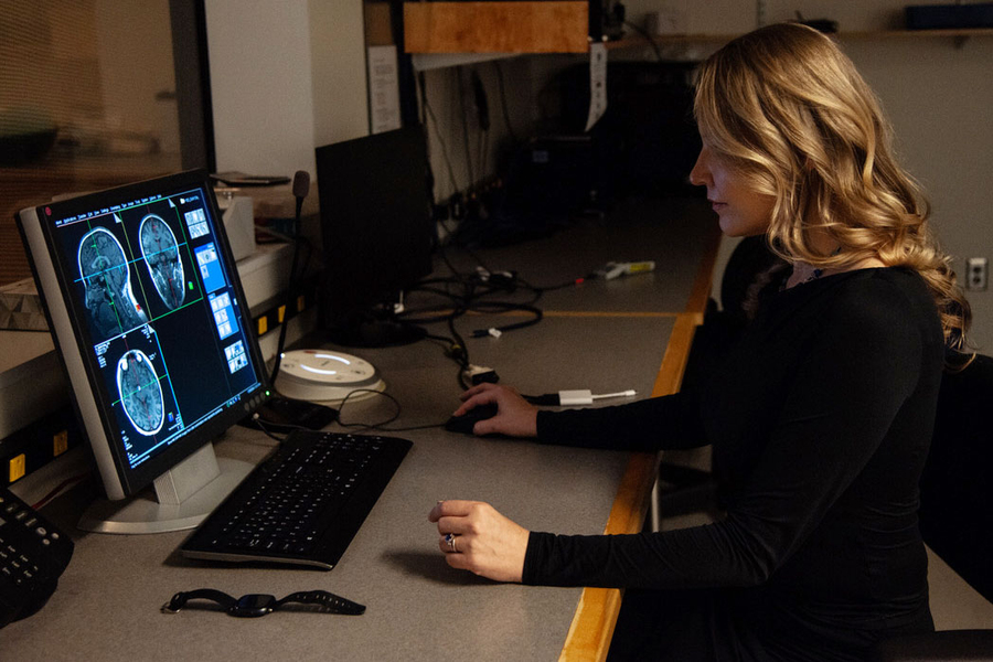 Evelina Fedorenko at computer looking at brain imagery.