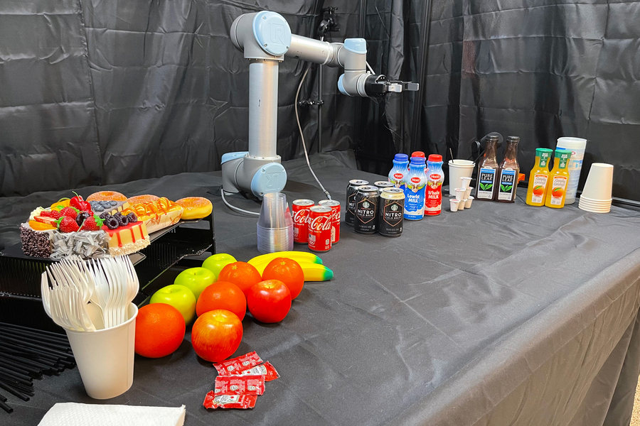 A robot arm surrounded by a variety of objects 