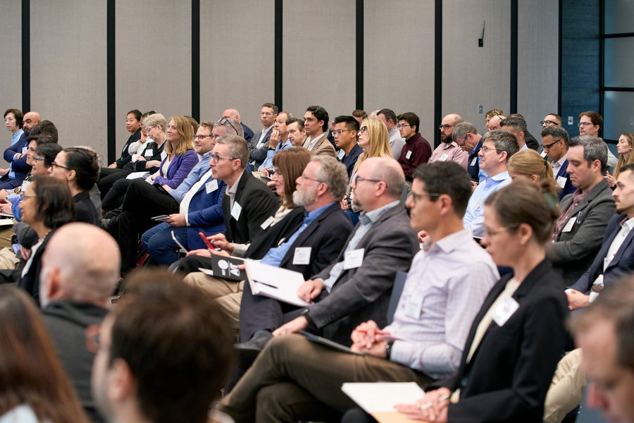 A portion of a large audience in a full auditorium