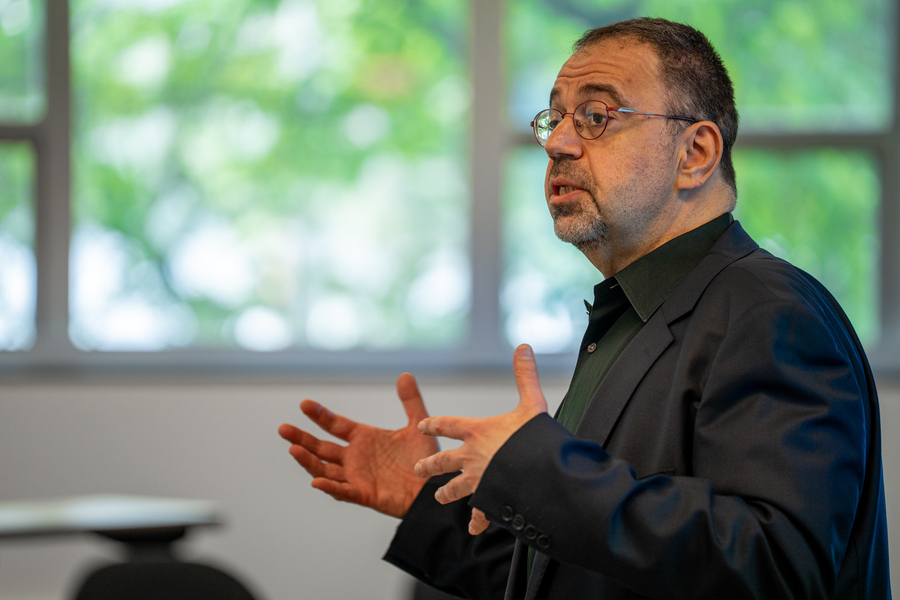 Profile photo of Daron Acemoglu addressing a class