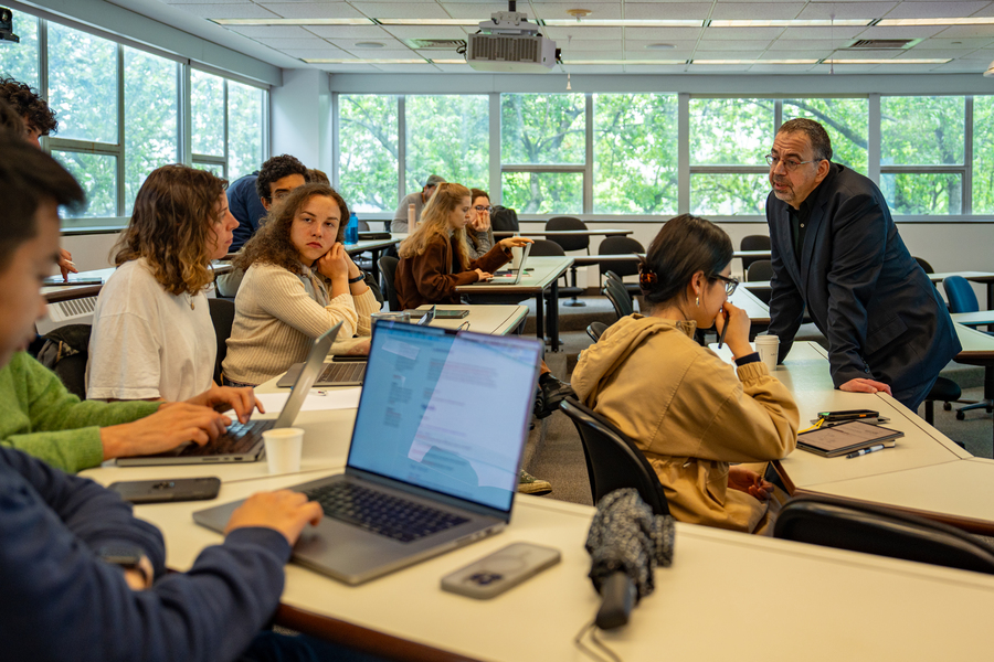About 10 students and a professor in class