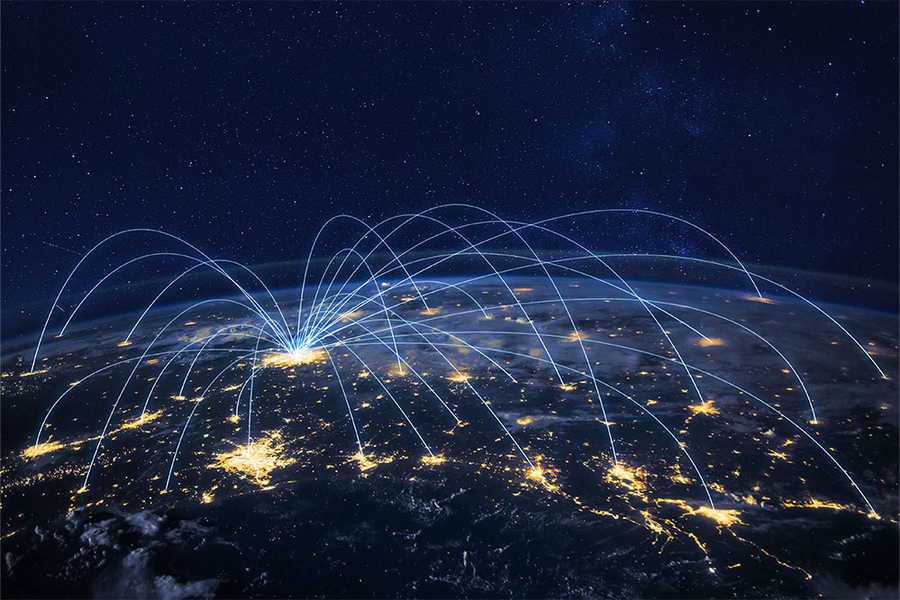 Realistic photo illustration of a portion of Earth's surface with clusters of city lights connected by arcing lines