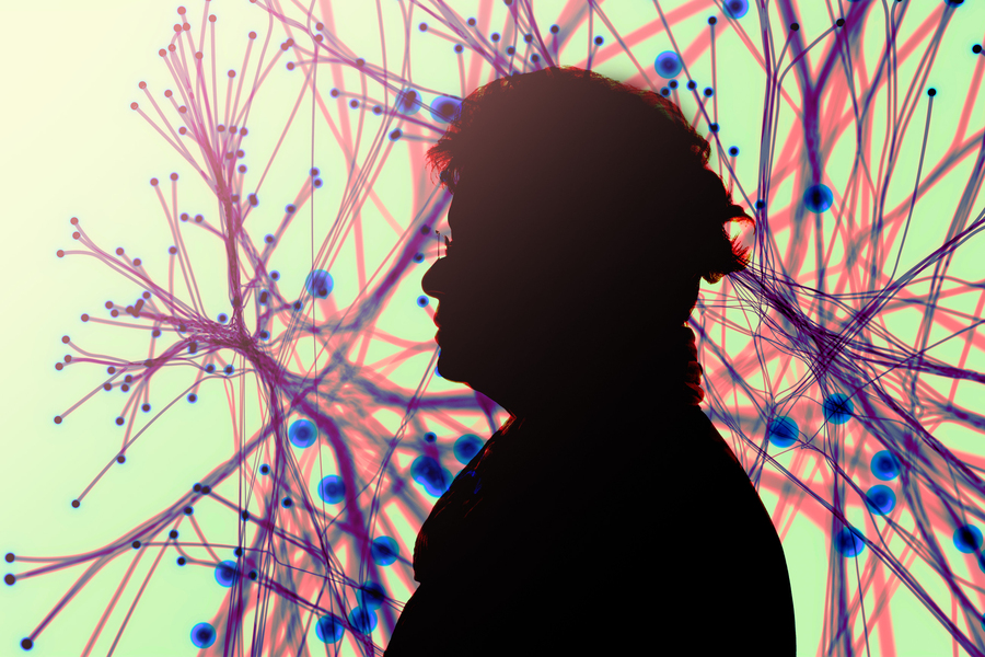 Silhouette of elderly person with neurons in background.