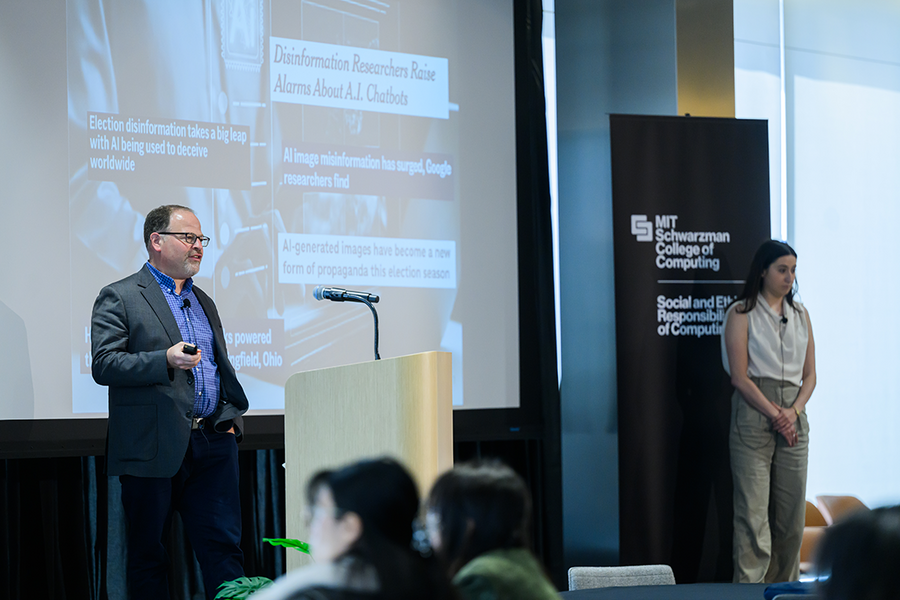 Adam Berinsky and Gabrielle Péloquin-Skulski give a lecture on a small stage indoors
