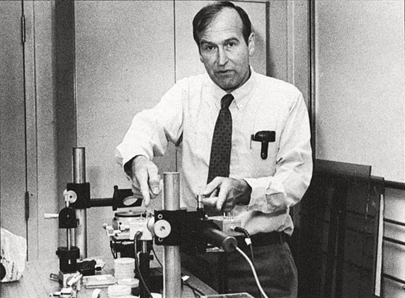 Grainy, grayscale photo of Hank Smith in a lab at MIT in 1988.