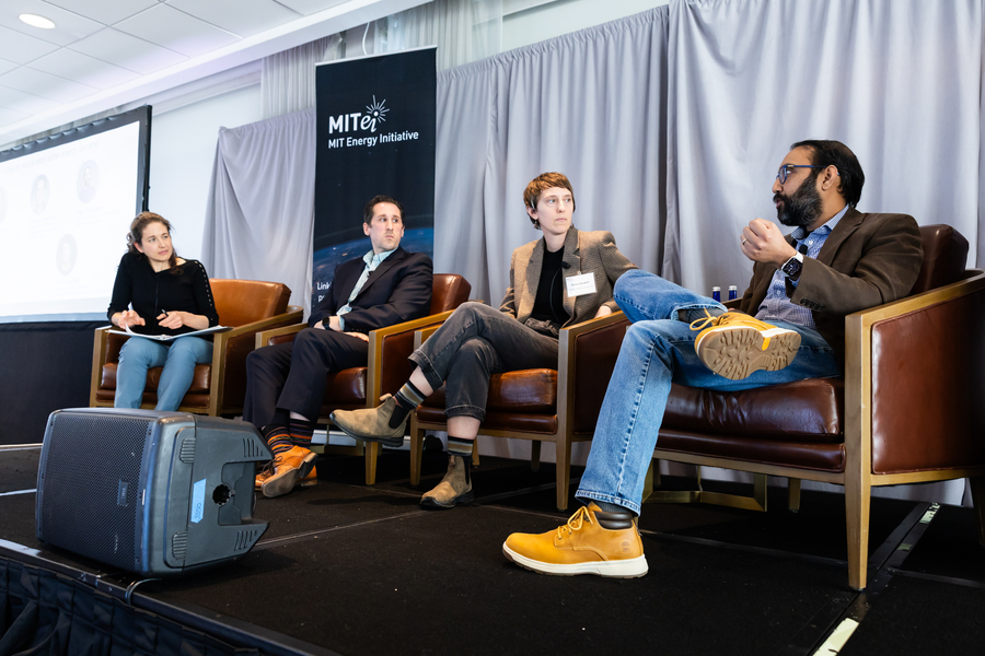 Panelists have a conversation on a stage. 
