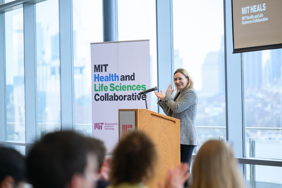 Angela Koehler speaks at a lectern in front of seated audience