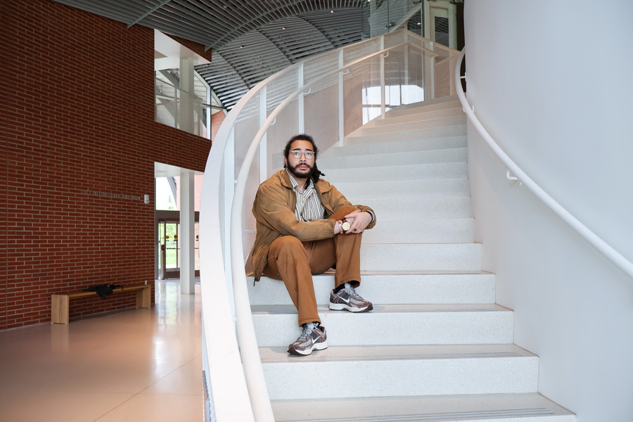 Thelonious Cooper sits on a curved indoor staircase.