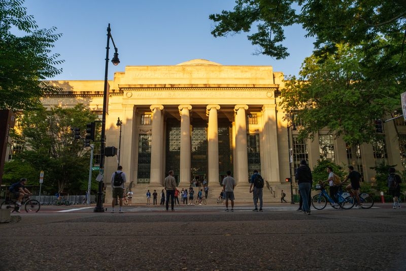 Photo of MIT building 7 with columns at sunset