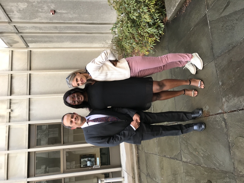Three people standing in front of McCormick Hall