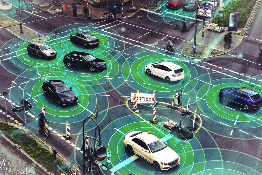Cars at an intersection with futuristic sensors around them.