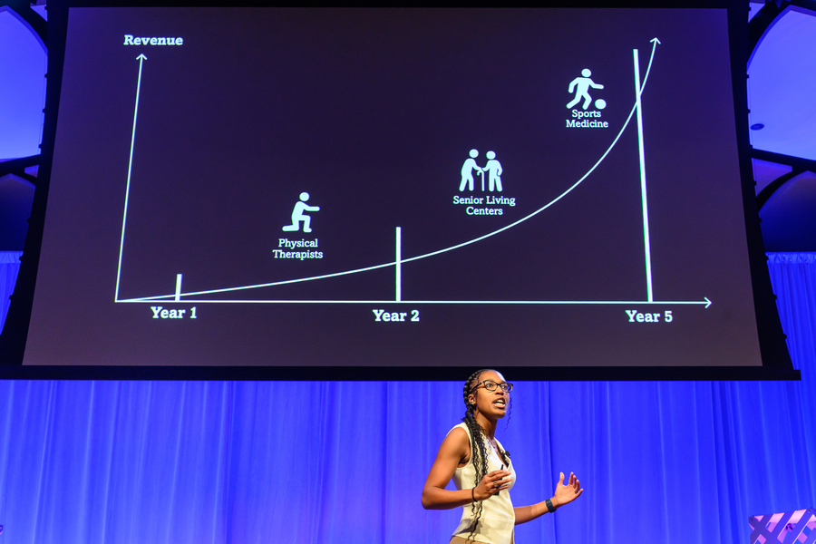 A female student presenting on stage