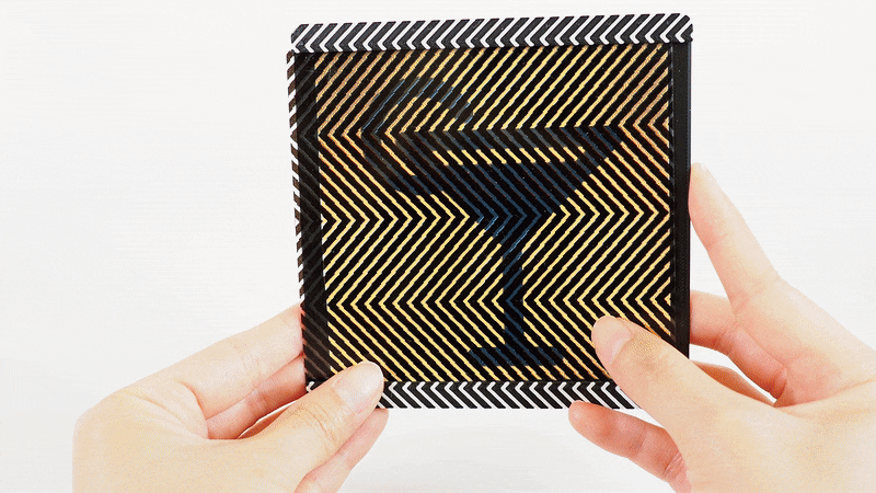Woman's hands hold a coaster that can switch from displaying a “coffee” icon to symbols of a martini and a glass of water.