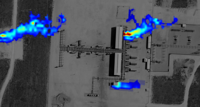 An overhead satellite image of a gas production site, with plumes of gas (colored to show concentration levels) emanating from 3 locations.