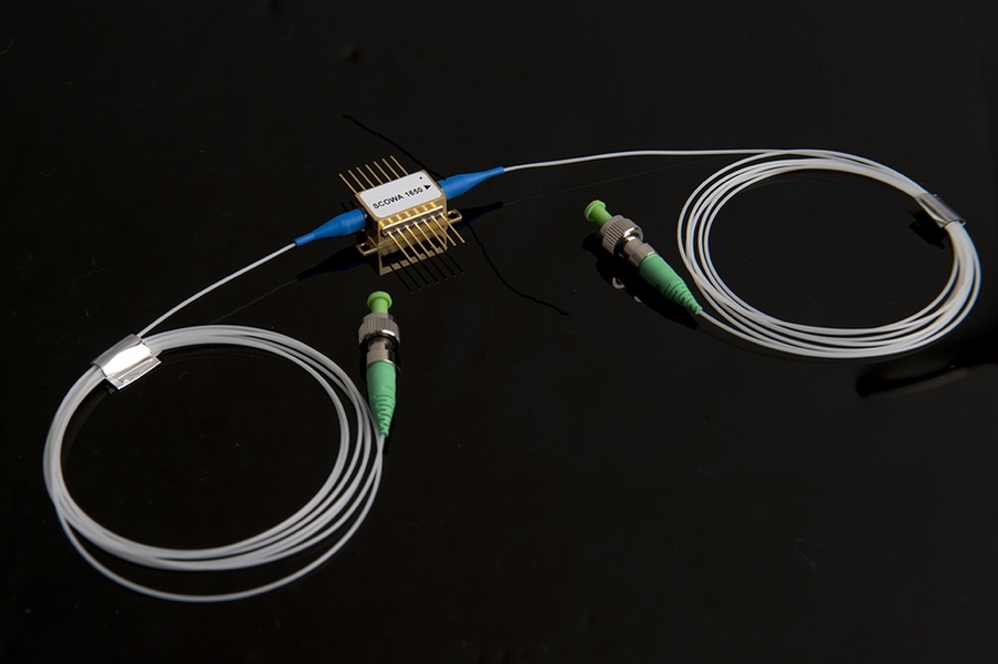 A photo of a packaged SCOWA device, which appears as two coils of wire connected to a base.