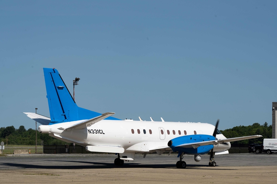 A turboprop passenger aircraft sits on the ground.