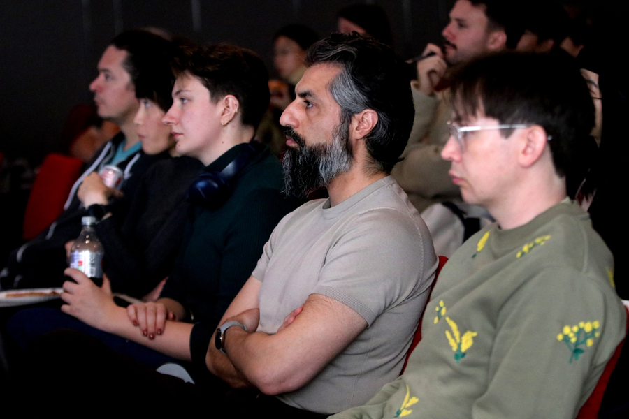 Participants listen to a speaker during a meeting