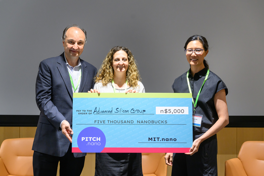 Vladimir Bulović, Marcie Black, and Joyce Wu pose holding a giant check.