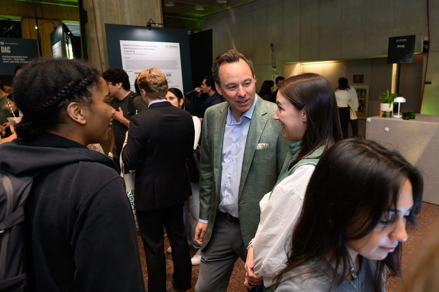 Several people in conversation in a crowded room.