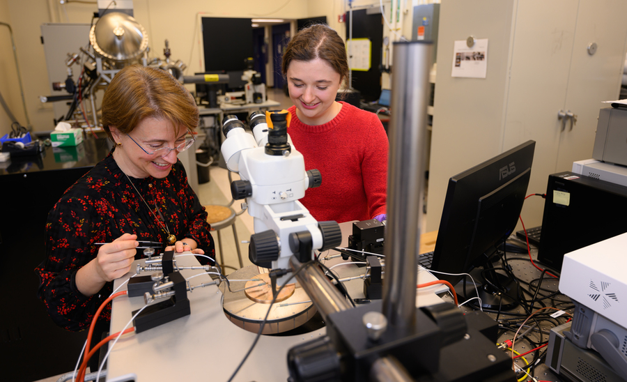 An MIT graduate student and her advisor work at a probe station, measuring the electrical resistance of a tungsten oxide film.