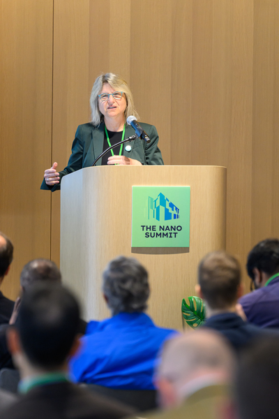 Sally Kornbluth speaks at a lectern. 
