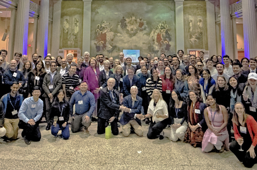 At least 100 TPP students, alumni, faculty, and staff posing for a group photo in Walker Memorial Hall.