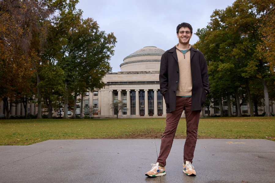 Benjamin Manning poses in front of MIT’s Great Dome and Killian Court in autumn