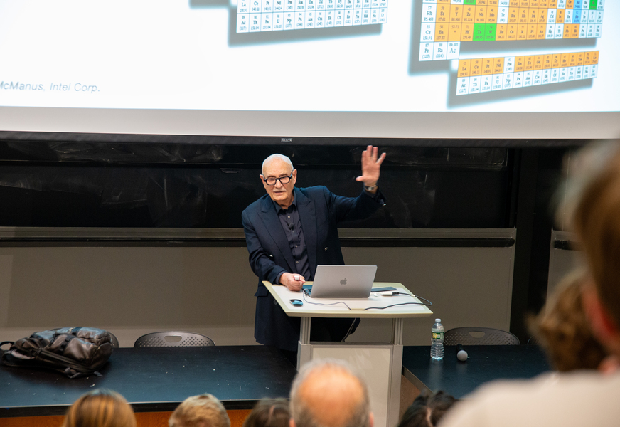 Diran Apelian stands at a lectern, gesturing while speaking to an audience