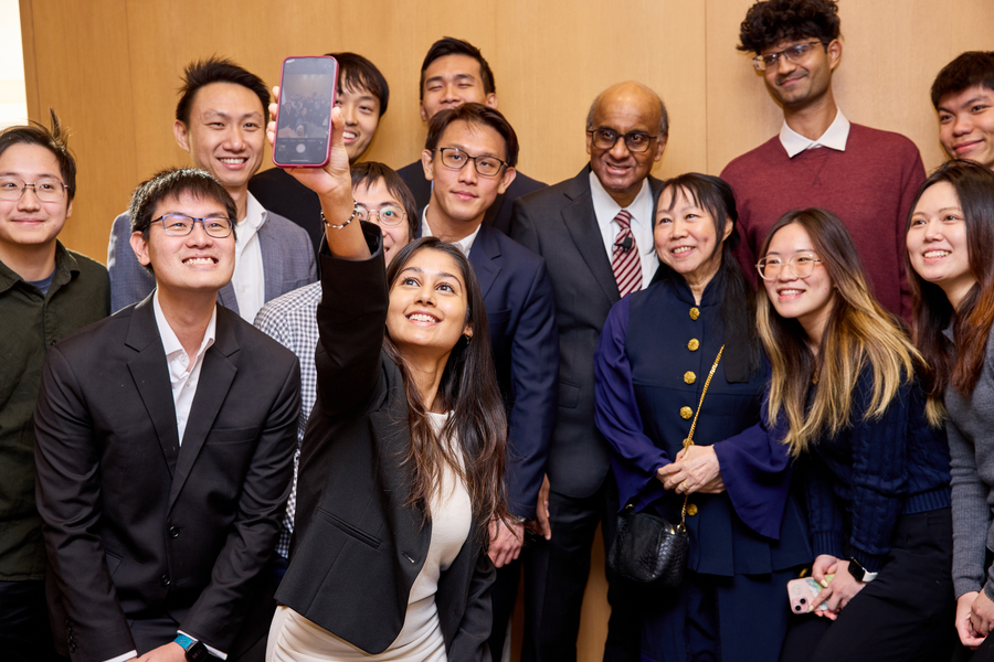 About 15 people pose for a group selfie, with Tharman and Ittogi in center.