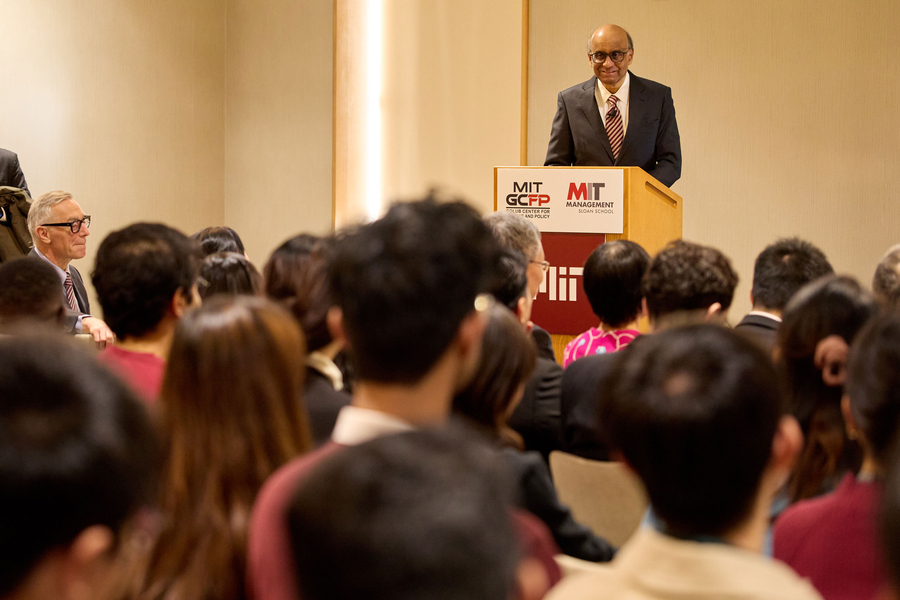 Tharman at podium, with blurry audience heads in the foreground.