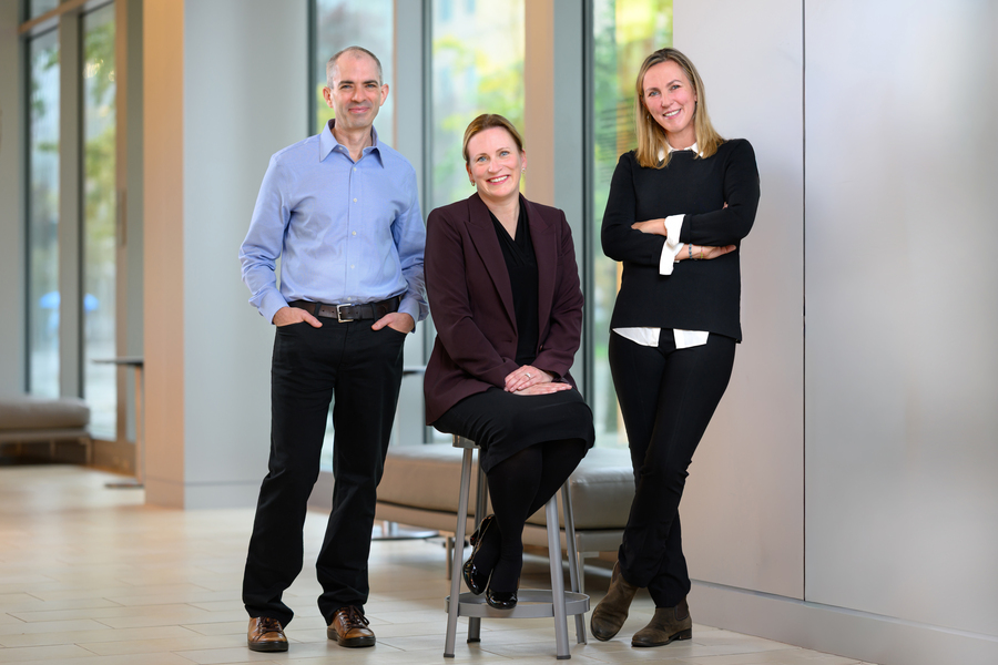 Angela Koehler, Iain Cheeseman, and Katharina Ribbeck, pose in a hall