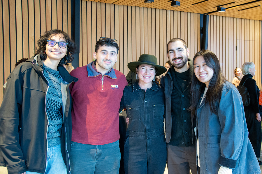 Four MIT students and Rhea Vedro pose together indoors