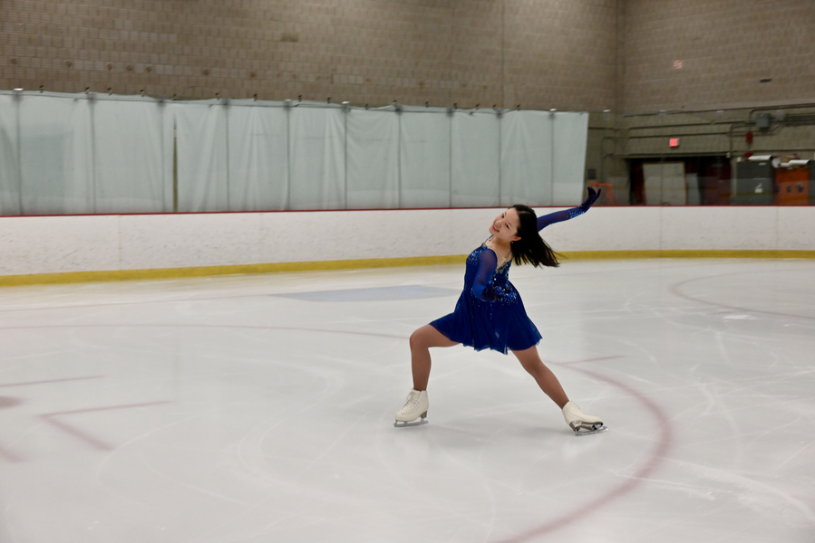 Eleanor Li figure skates in an ice rink